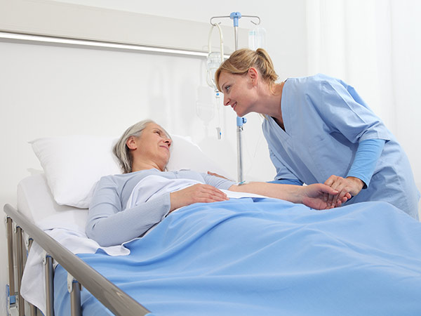 Patient lying in bed with physician Consulting.