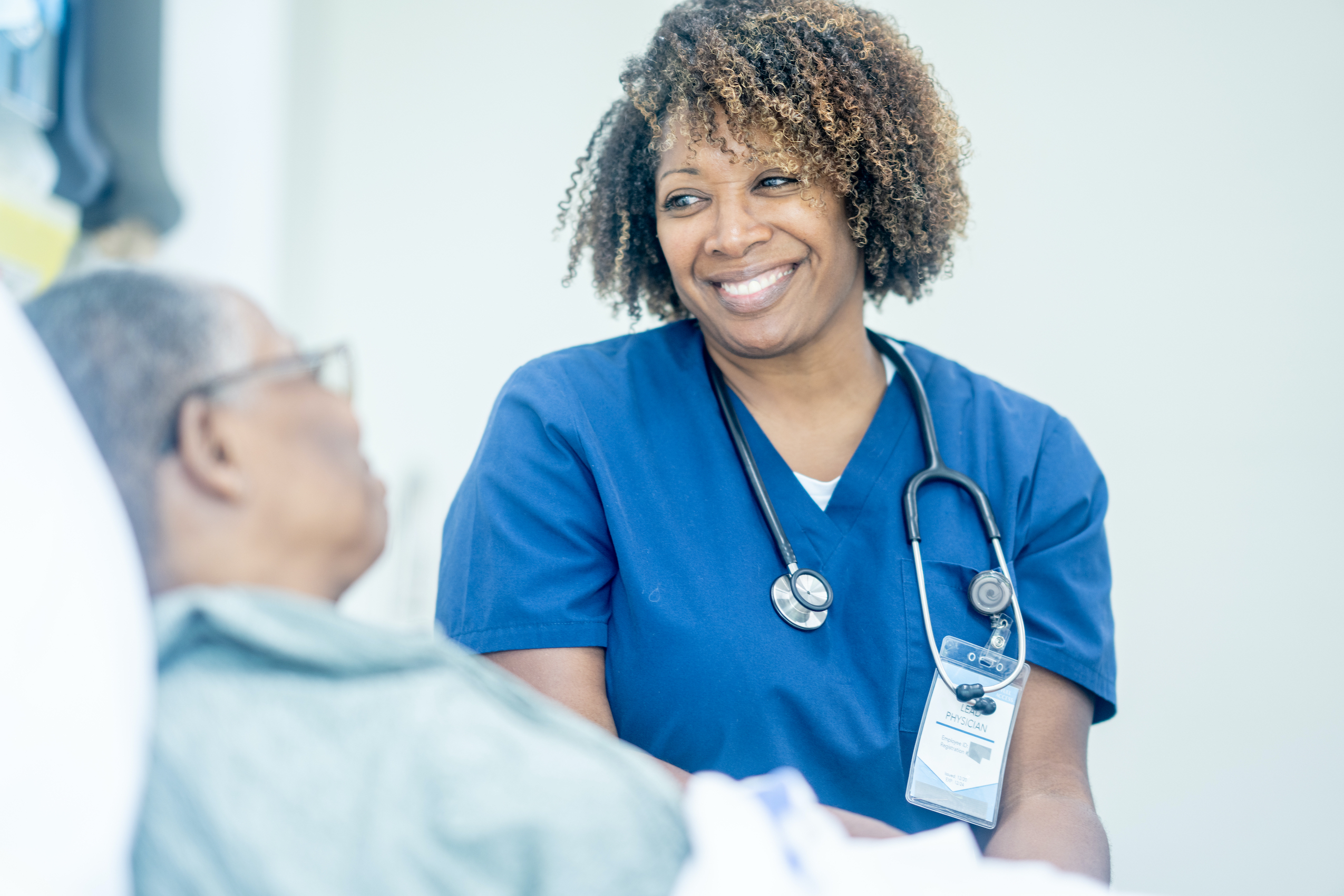Nurse looking at elderly patient with helpful eyes.