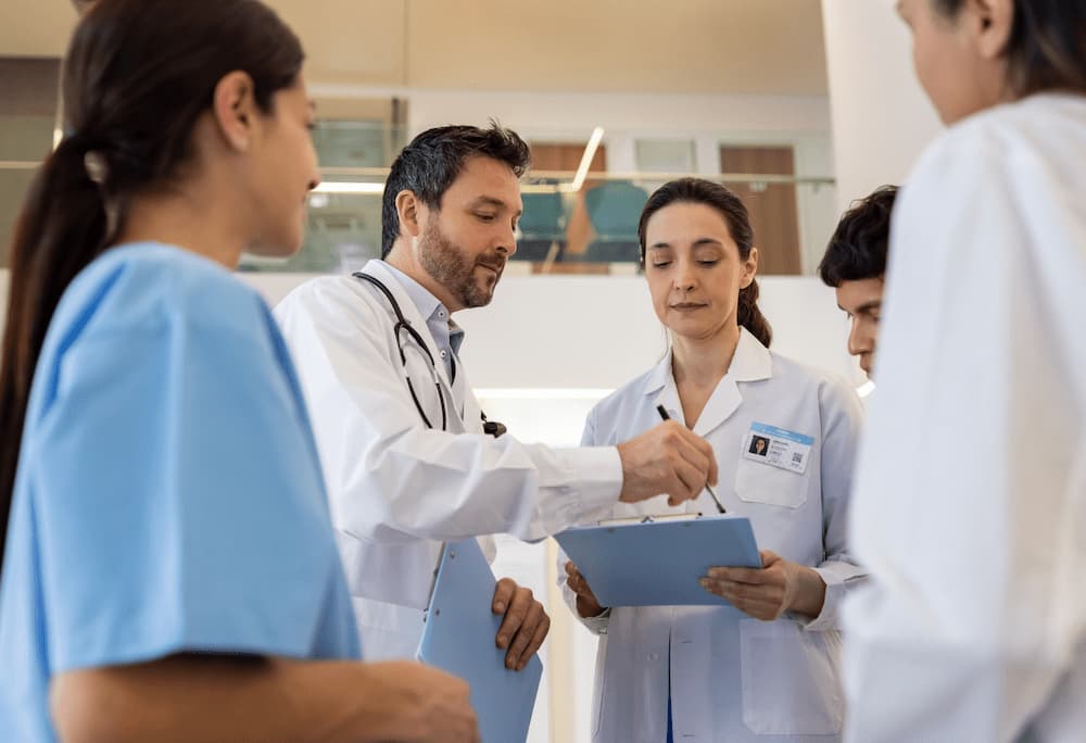 Doctor Consulting with Resident Physicians