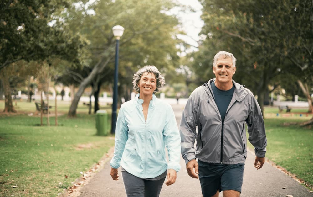 Happy couple walking on a trail.