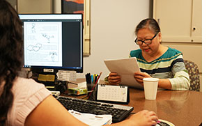 Woman with Speech Pathologist Reading Words.