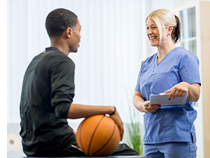 Boy basketball player talking to doctor.