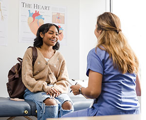 Girl talking to a woman doctor.
