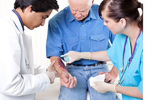 Doctor treating patient with cotton swab.